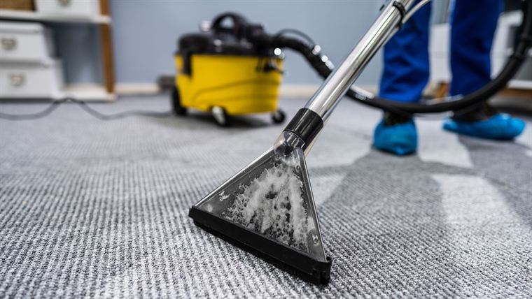 Carpet extraction machine lifting dirt from a carpet