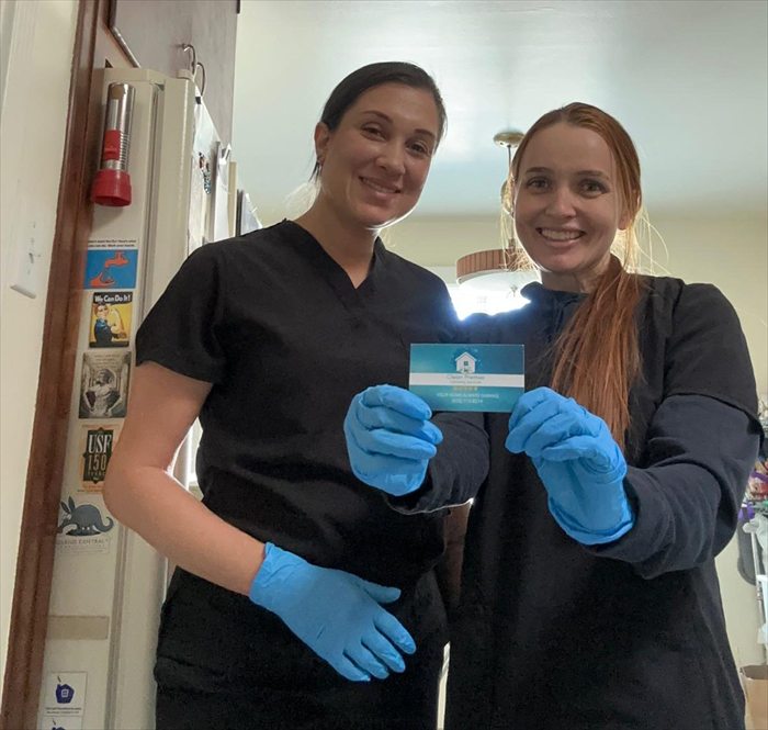 Two members of the Fabi's House Cleaning team in a client's kitchen
